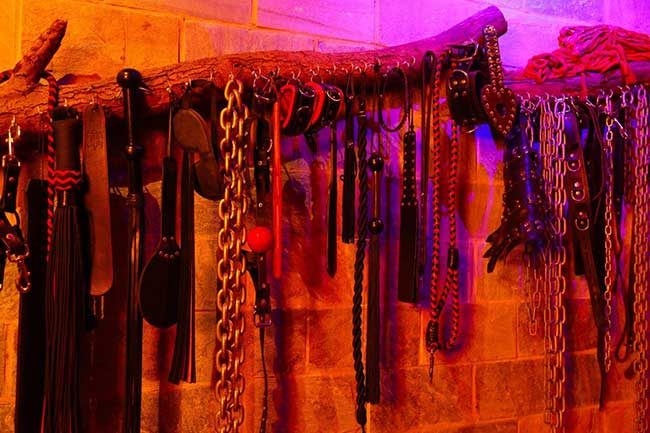 Wall of floggers, cuffs and chains